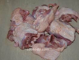 Duck fried in pieces in a frying pan